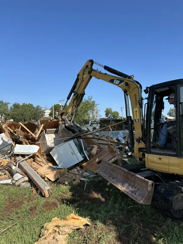 CAT mini excavator demolishing mobile home