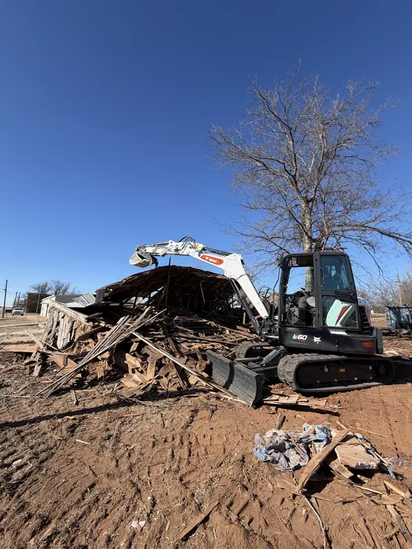Takeuchi excavator — mobile home teardown in progress