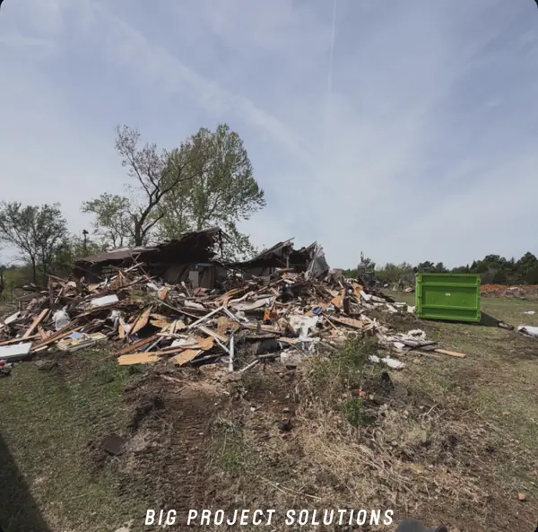 Old house before demolition — Bobcat & roll-offs ready