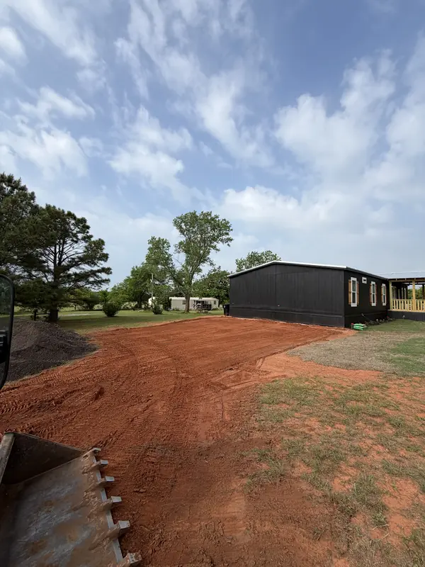 New home site — concrete driveway and graded yard