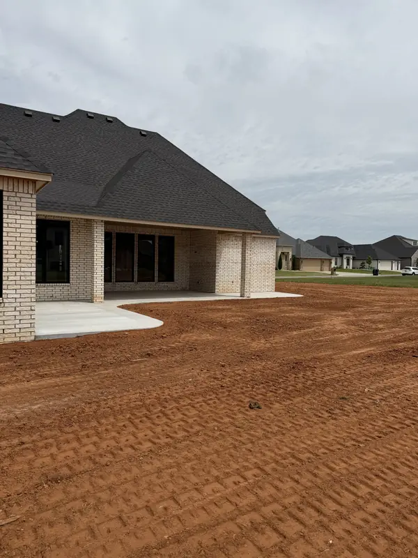 New home site — graded lot wide view with BPS truck